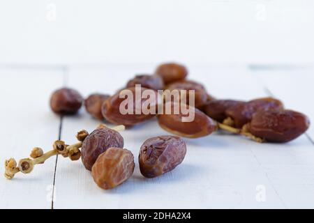 A few dates on an old white wooden table with copy space Stock Photo