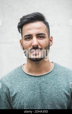 Portrait of confident businessman standing against wall Stock Photo