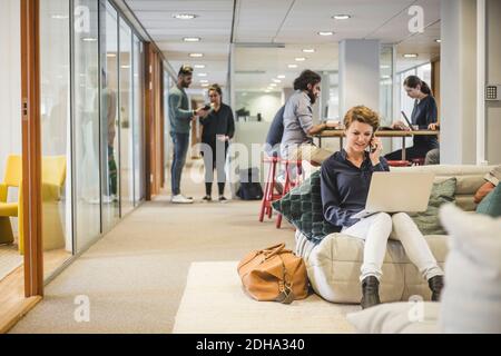 Male and female business professionals working in creative office Stock Photo