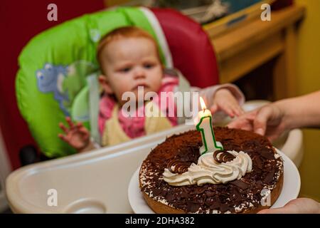 One year old baby girl chocolate cake smash party Stock Photo