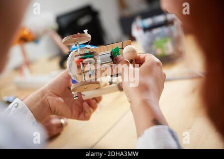 Cropped image of multi-ethnic female technicians making model at workshop Stock Photo