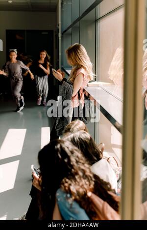 Female students in school corridor during lunch break Stock Photo