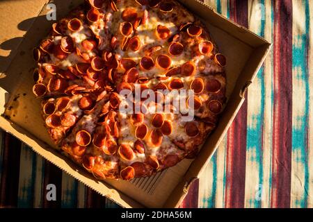 Large Pepperoni Pizza Delivered (overhead) Stock Photo