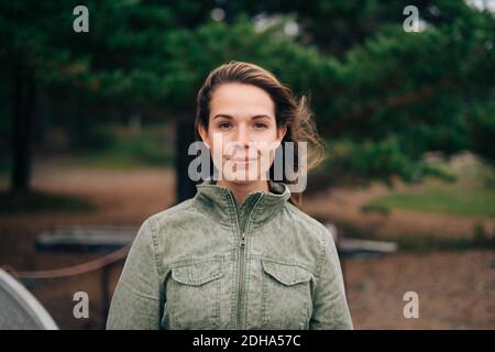 Portrait of confident young woman standing at beach Stock Photo
