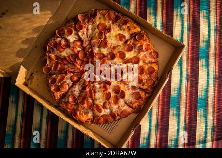 Large Pepperoni Pizza Delivered (overhead) Stock Photo