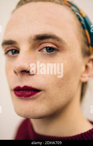Close-up portrait of young man against wall Stock Photo