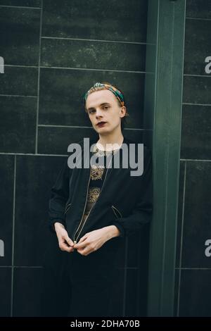Portrait of young man standing against wall Stock Photo