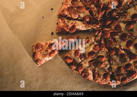 A Whole Pepperoni Pizza with a Slice removed Stock Photo