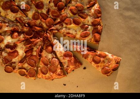 A Whole Pepperoni Pizza with a Slice removed Stock Photo