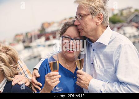 Loving senior couple holding champagne flutes during summer vacation Stock Photo