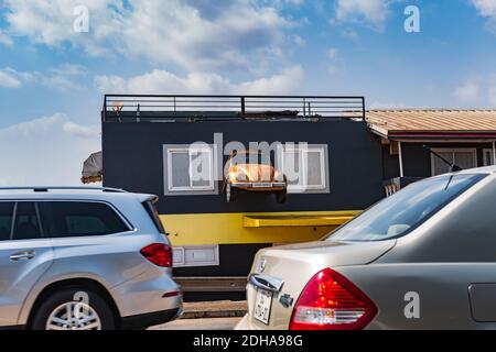 A Volkswagen car mounted on a wall after a busy road in the city of Accra Ghana West Africa 18 November 2020 Stock Photo