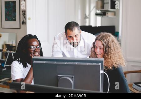 Multi-ethnic business people using computer in creative office Stock Photo