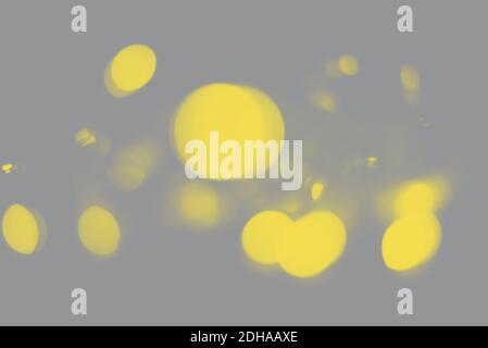 Blurred yellow sparkles on the grey background. Trendy colors. Yellow and Gray. Demonstrating Color 2021. Stock Photo