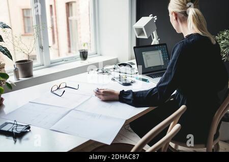 Female engineer working on desk at home office Stock Photo