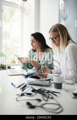 Female colleagues working on table in home office Stock Photo