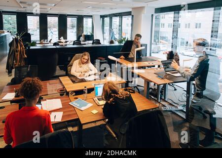 Coworkers working at desk in office Stock Photo