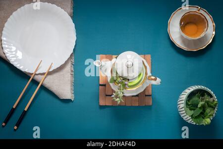 Empty white plate, chopsticks and herbal tea Stock Photo
