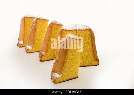 Pandoro, typical Italian Christmas dessert, cake cut with slices with powdered sugar isolated on white Stock Photo