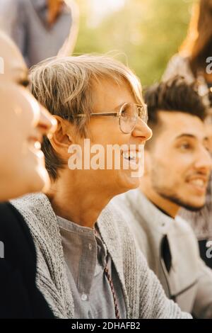 Male and female friends smiling at social gathering Stock Photo