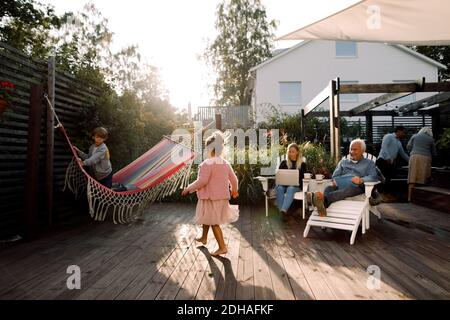 Multi-generation family spending leisure time in backyard during weekend Stock Photo