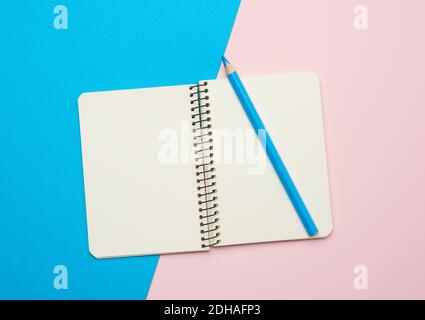 Open notepad with empty white sheets on a blue background Stock Photo