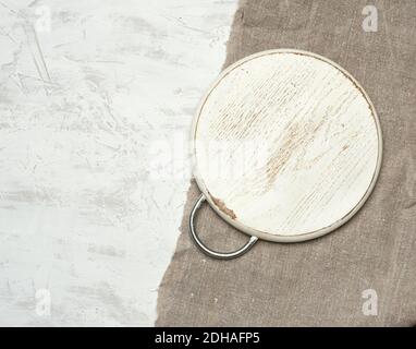 Empty round small cutting board lie on a white background Stock Photo