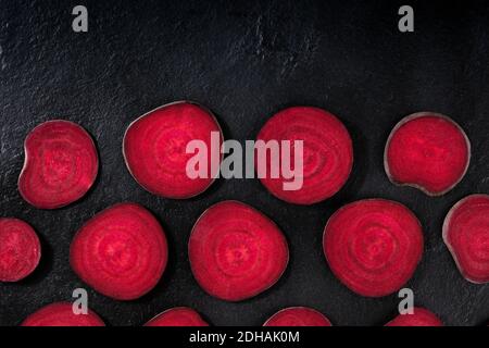Beetroot design layout. Slices of beet, shot from the top on a black background with copy space Stock Photo
