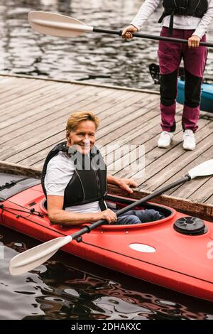 Portrait of smiling senior man sitting in kayak during kayaking course Stock Photo