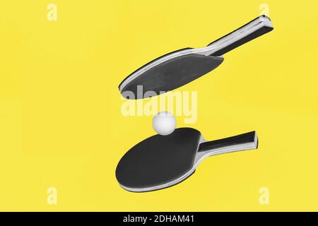 Ultimate Gray ping pong rackets on Illuminating Yellow background Stock Photo