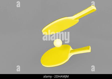 Illuminating yellow ping pong rackets on Ultimate Gray background Stock Photo