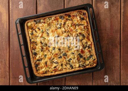 A zucchini and goat cheese pie with sage, shot from above in a baking sheet Stock Photo