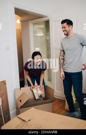 Couple enjoying while unpacking boxes in new apartment Stock Photo