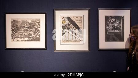 Bonhams, London, UK. 10 December 2020. Bonhams Prints and Multiples sale preview. Image (left to right): Paul Nash (1889-1946), Mine Crater, Hill 60 (Postan L1). Lithograph, 1917, on Antique deluxe laid paper, signed, dated Dec 1917 and numbered 18/25. Estimate £12,000-18,000; Christopher Richard Wynne Nevinson A.R.A (1889-1946), Banking at 4,000 Feet, estimate: £15,000-20,000; Christopher Richard Wynne Nevinson A.R.A (1889-1946), Acetylene Welder (Black 17). Lithograph, 1917, on wove paper, signed, dated and numbered 5. Estimate £4,000-6,000. The sale takes place on 15th December 2020. Credit Stock Photo