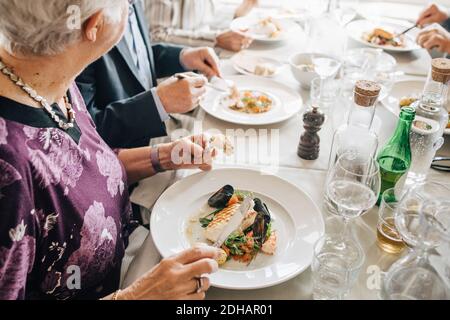 High angle view of Senior woman with food in restaurant Stock Photo