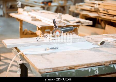 Brushing and grinding hand machine on the wooden product at the carpentry Stock Photo