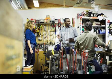 Multi-ethnic coworkers discussing at workshop Stock Photo