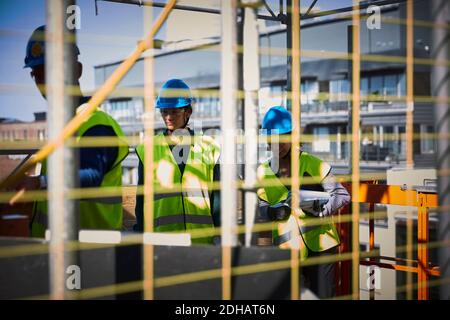 Male and female engineers in workwear at construction site Stock Photo