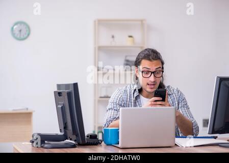 Young male it specialist working in the office Stock Photo