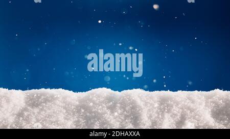 A thick layer of snow on blue background. Winter holidays background with snow texture. Stock Photo