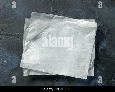 white baking paper sheets on blue painted background, top view Stock Photo