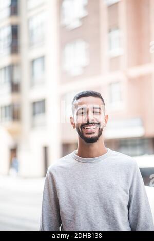 Portrait of smiling young man standing outdoors Stock Photo