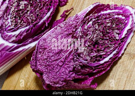 close-up topview of red chinese cabbage, on a wooden board background. selective focus photo of red cabbage. Stock Photo