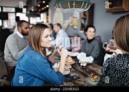 Women having brunch with friends at table Stock Photo