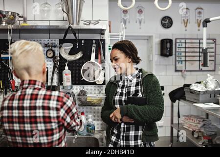 Female workers discussing while working in brewery Stock Photo