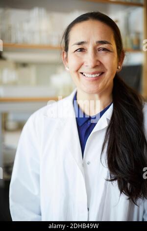 Portrait of confident mature female teacher standing in university classroom Stock Photo