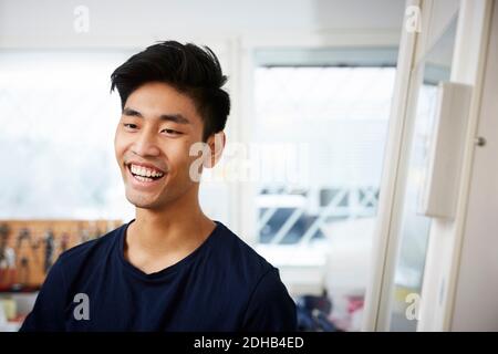 Smiling young man standing in university laboratory Stock Photo