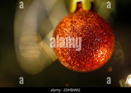 Shallow depth of field (selective focus) image with a red ornament in a plastic Christmas tree. Stock Photo