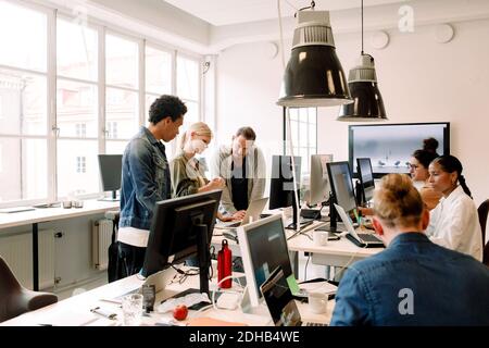 Creative business people working on computers in open plan office Stock Photo