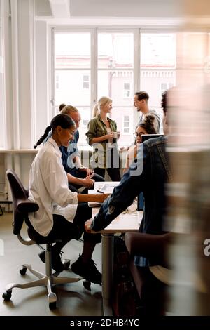 Male and female executives working in creative office Stock Photo
