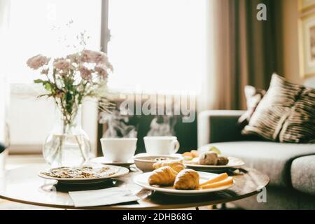 Breakfast served on table in hotel room Stock Photo